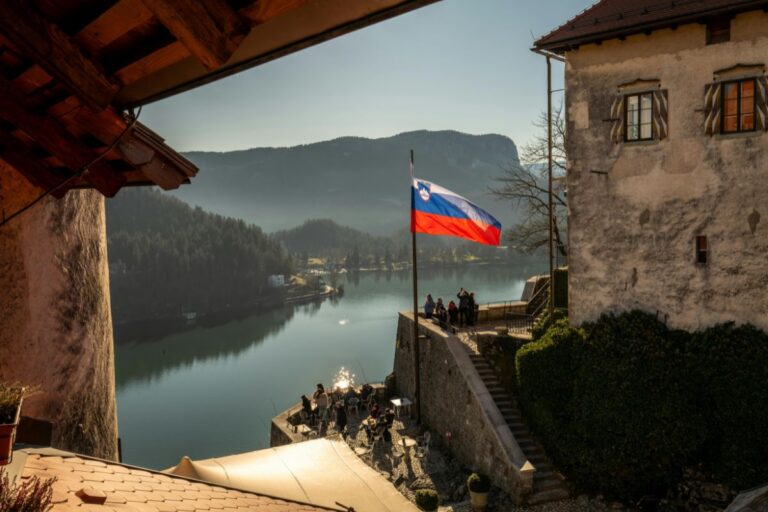 View from Bled Castle over Lake Bled with the Slovenian flag.