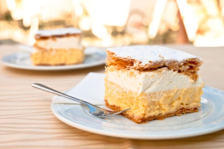 Traditional Bled cream cake on a plate with whipped cream.