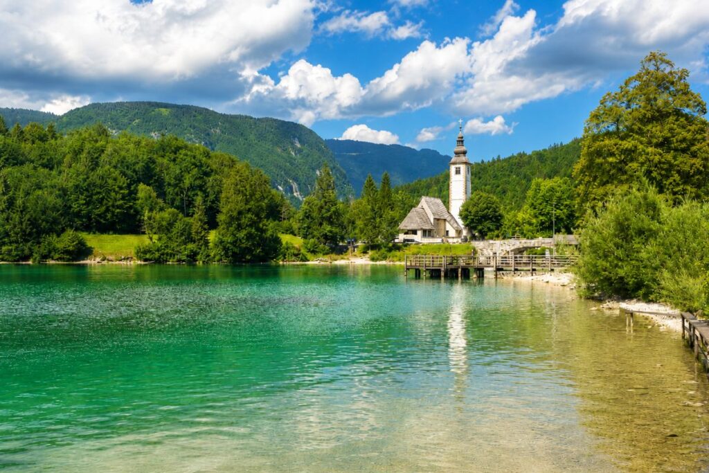 The stone bridge and St. John the Baptist Church beside Lake Bohinj.
