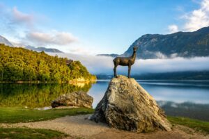 The Zlatorog statue on a rock beside Lake Bohinj.
