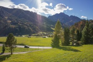 Green valley and forested hills near Kranjska Gora with alpine peaks in the background.