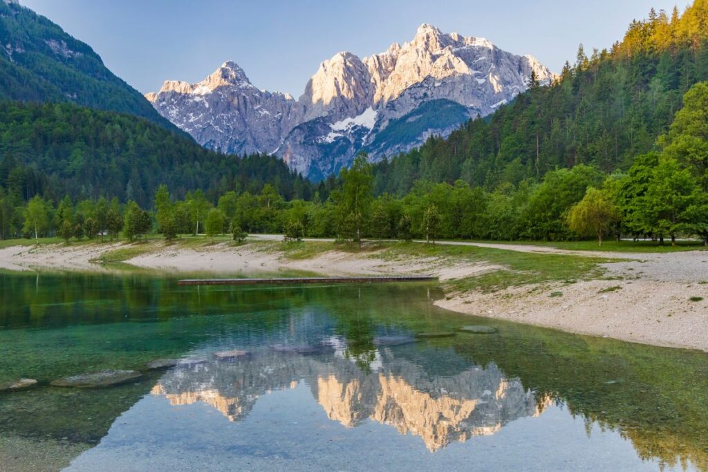 Calm Lake Jasna reflecting the mountains and blue sky.