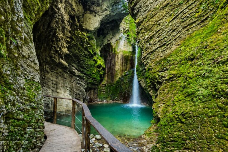 Kozjak Waterfall Wooden walkway leading to Kozjak Waterfall and its emerald pool in a rocky gorge near Kobarid